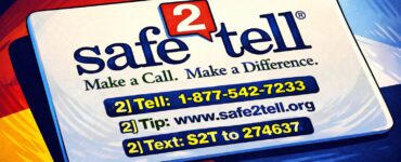 A high school hallway with a police officer talking to an administrator near lockers